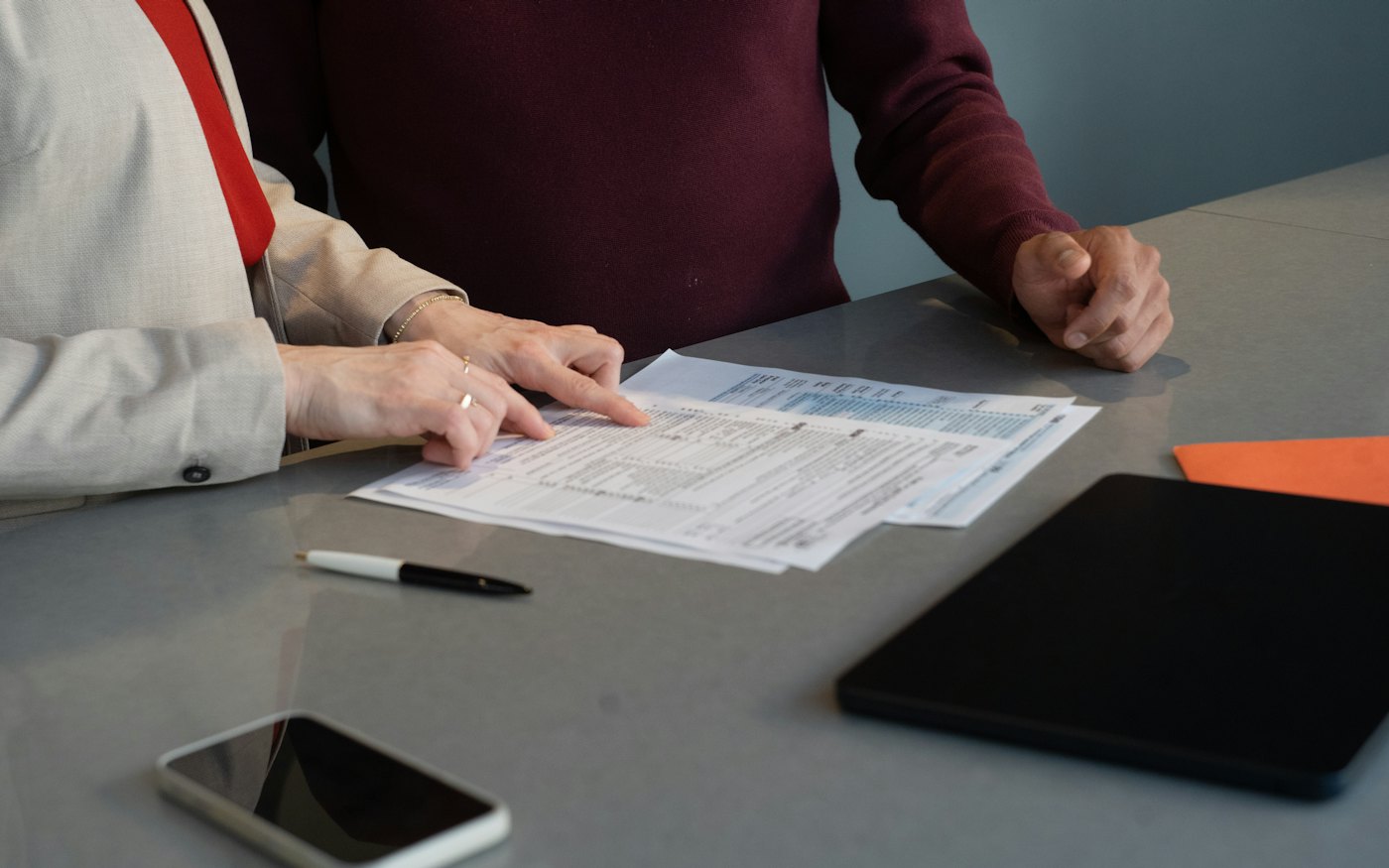 Two people reviewing documents together at a table
